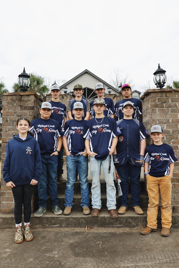 Richland Creek Top Guns squad in team jerseys on the clubhouse steps
